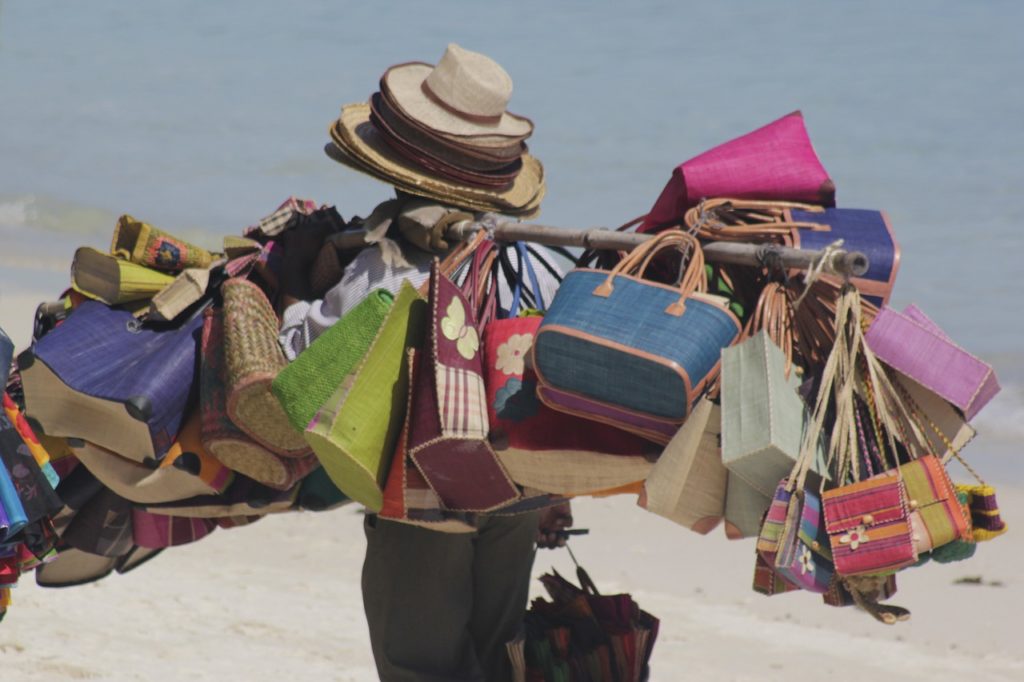 man selling bags on the beach