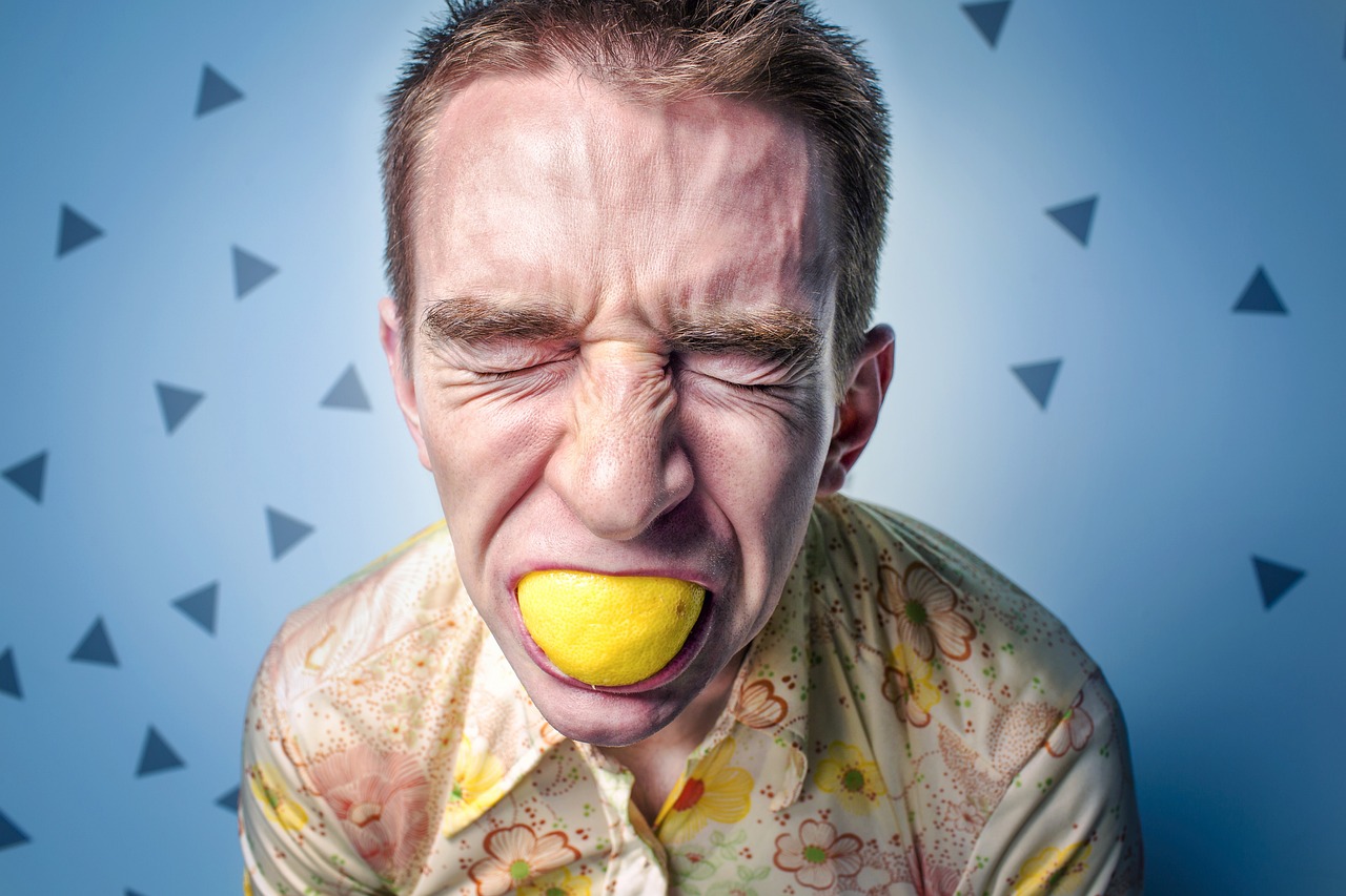 man eating a lemon